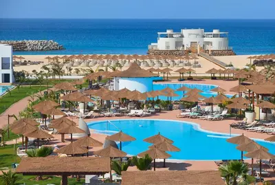 an aerial view of a resort with a pool and umbrellas at Meliá Laguna Beach in Santa Maria