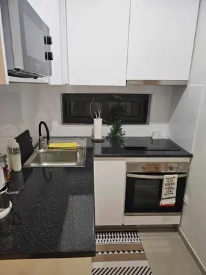 a small kitchen with a sink and a microwave at Sheila Apartment in Espargos