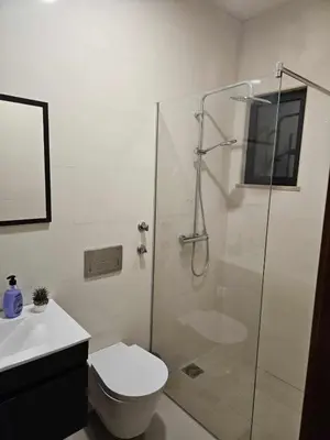 a bathroom with a shower and a toilet and a sink at Sheila Apartment in Espargos