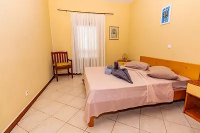 a bedroom with a bed and a chair in it at T1 - 800m from the beach - located in the city center in Santa Maria