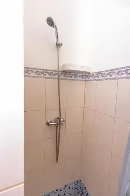 a shower with a shower head in a bathroom at T1 - 800m from the beach - located in the city center in Santa Maria