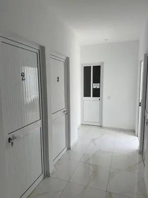 a white room with two doors and a tiled floor at MeloMar Rooms in Ponta do Sol