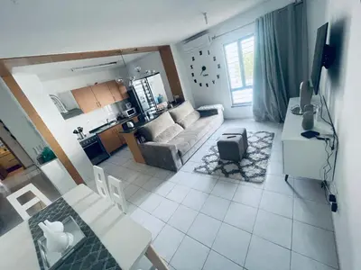 a living room with a couch and a table at APPARTEMENT IDEAL POUR ESCALE a PRAIA in Praia