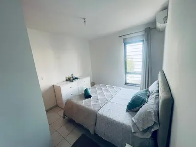 a small bedroom with a bed and a window at APPARTEMENT IDEAL POUR ESCALE a PRAIA in Praia