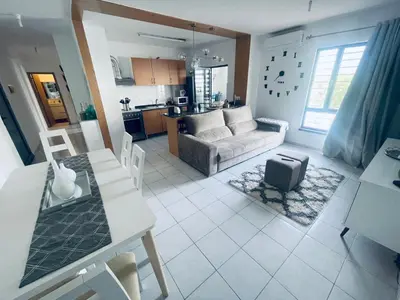 a living room with a couch and a table at APPARTEMENT IDEAL POUR ESCALE a PRAIA in Praia