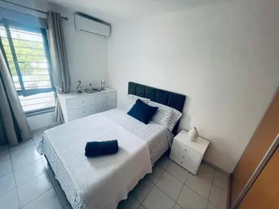 a bedroom with a bed with blue pillows on it at Dormir à Praia Cap vert autour de l'aéroport in Praia