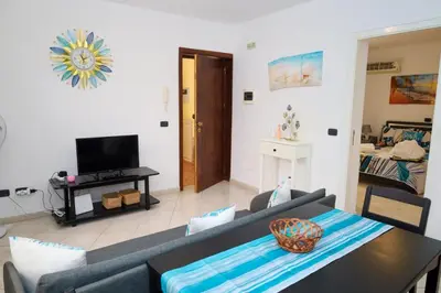 a living room with a couch and a table at 1 bedroom apartment with sofa bed 4 min walk from the beach in Santa Maria