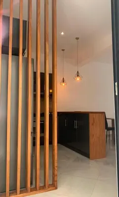 a living room with a kitchen with a table at NOBRE LUZ T2 Boa Vista in Sal Rei
