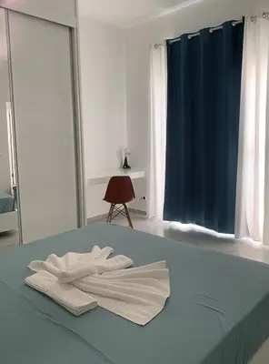 a bed with two white towels on top of it at NOBRE LUZ T2 Boa Vista in Sal Rei