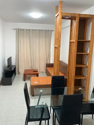 a living room with a table and a couch at Prédio IFH Maio in Vila do Maio