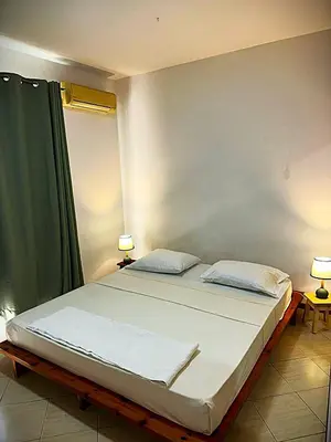 a bedroom with a large bed with two pillows at Mira Mar Condominium, Palmarejo Baixo in Praia