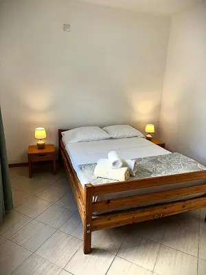 a bedroom with a bed with two towels on it at Mira Mar Condominium, Palmarejo Baixo in Praia