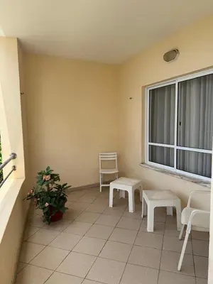 a balcony with chairs and a window and a plant at Mira Mar Condominium, Palmarejo Baixo in Praia