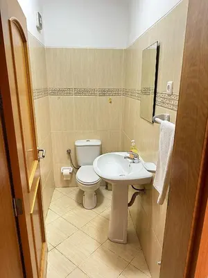 a bathroom with a white toilet and a sink at Mira Mar Condominium, Palmarejo Baixo in Praia