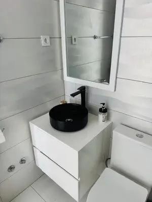 a bathroom with a black sink and a mirror at Sweet Apartment Palmarejo - Marina Residence in Praia