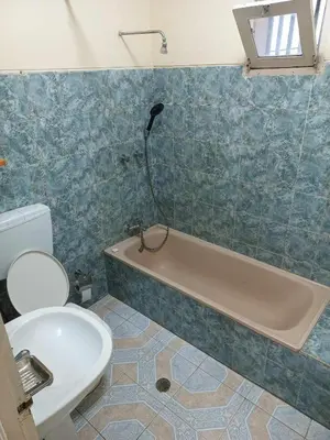 a bathroom with a tub and a toilet and a sink at Casatata in São Filipe