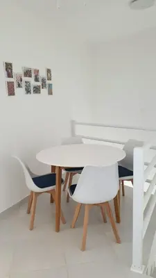 a white table and chairs in a room at Residência Alto Saco, Double room with private bathroom in Tarrafal