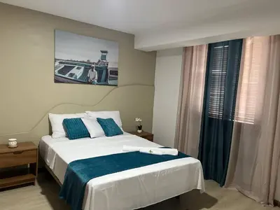 a bedroom with a large bed and a window at Plateau- Sea View Apartment in Praia