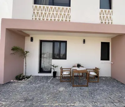 a table and chairs in front of a building at Crown Paradise Beach Lagoon Studio in Sal Rei