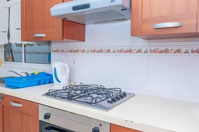 a kitchen with a stove top oven in a kitchen at Chã de Areia Lounge Vista Mar - Apartamento T2 in Praia