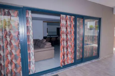 a living room with sliding glass doors and a couch at Otro Residence in Praia