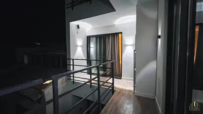 a view of a balcony at night with a staircase at Serenity in Praia