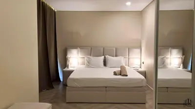 a bedroom with two beds and a mirror at Serenity in Praia