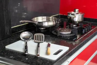 a kitchen counter with utensils on a stove at T2 com escritório - Férias Teletrabalho in Praia