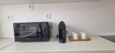 a television and a remote control sitting on a counter at Sal Casa VILLAGE in Santa Maria