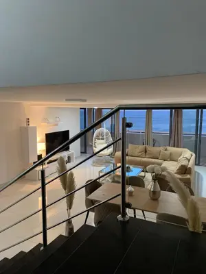 a living room with a couch and a table at Nice Duplex in Praia