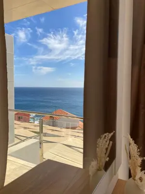 a view of the ocean from a room with a window at Nice Duplex in Praia