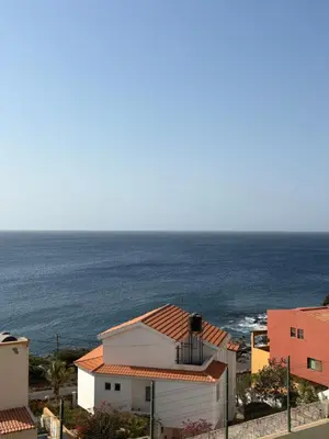 a view of the ocean from a building at Nice Duplex in Praia