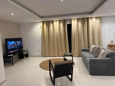 a living room with a couch and a flat screen tv at Penthouse Ocean View in Mindelo