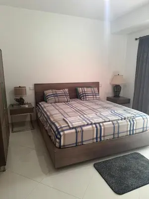 a bedroom with a bed with two night stands and two lamps at Penthouse Ocean View in Mindelo