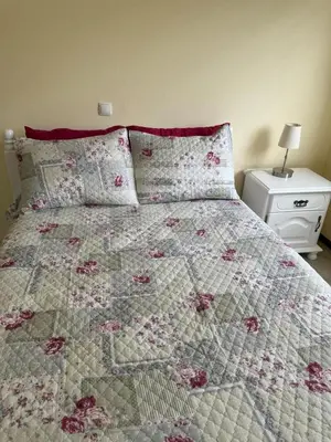 a bedroom with a bed with a quilt on it at Affordable Beach Town Apartment in Santa Maria