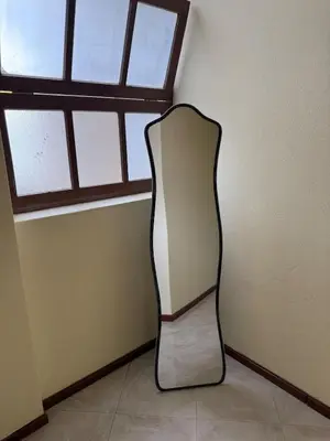 a chair in a corner of a room with a window at Affordable Beach Town Apartment in Santa Maria