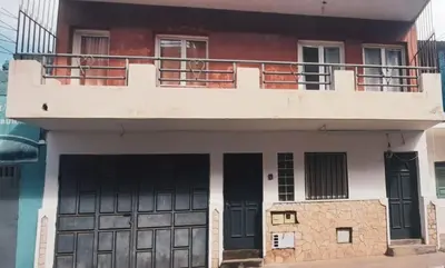 a house with a balcony on top of it at Tarrafal snuggle in Tarrafal