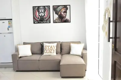 a living room with a couch and three pictures on the wall at Casa Berta - Downtown Apartment in Praia