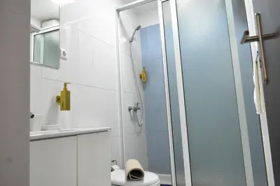 a bathroom with a glass shower with a toilet at Casa Berta - Downtown Apartment in Praia