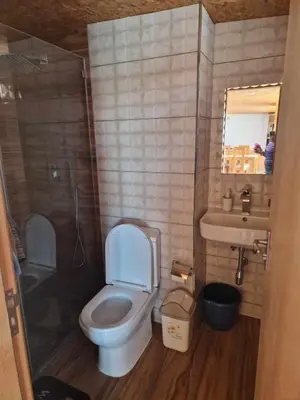 a bathroom with a toilet and a sink and a mirror at Apartamento Borges in Praia