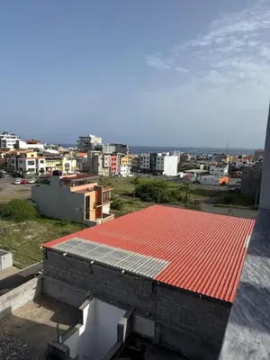 a red roof on top of a building at Apartamento Borges in Praia