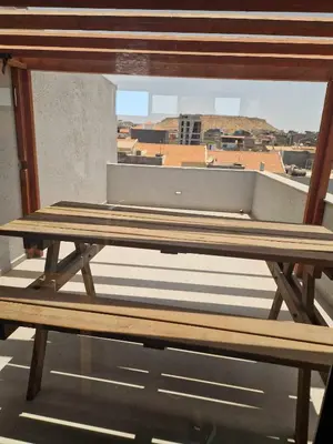 a wooden bench sitting on top of a balcony at Apartamento Borges in Praia