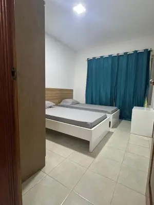 a bedroom with a bed and a blue curtain at Paz, Tranquilidade e Conforto in Espargos