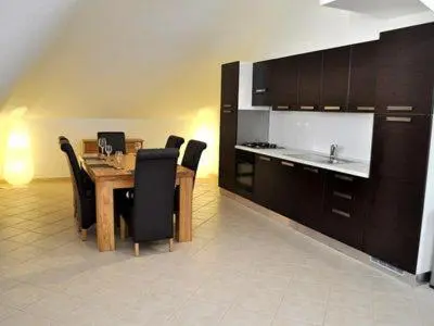 a dining room with a wooden table and black chairs at Stunning, spacious penthouse in beach front Leme Bedje Residence in Santa Maria