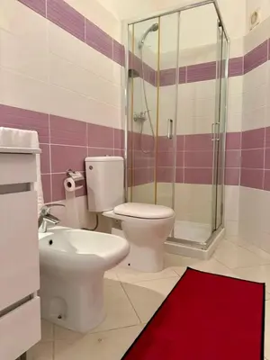a bathroom with a toilet and a shower at Estrela Mar - Wi-Fi included in Santa Maria