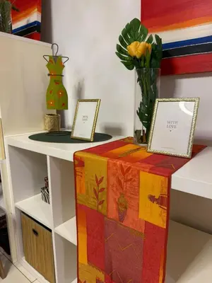 a colorful box on a shelf with a vase of flowers at Vila Verde TownHouse T53 by RPG Group in Santa Maria