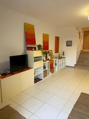 a living room with a tv and a white tile floor at Vila Verde TownHouse T53 by RPG Group in Santa Maria