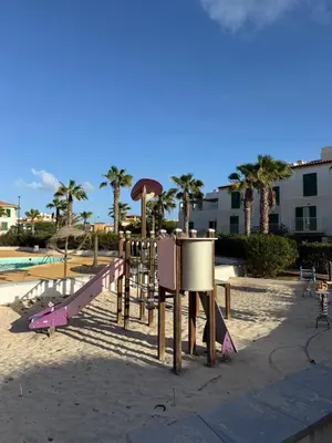 a playground in the sand with a slide at Vila Verde TownHouse T53 by RPG Group in Santa Maria