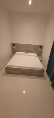 a bed in a white room with a bedvisor at Apartamento Duplex Boa Vista in Sal Rei