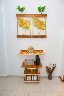a shelf with two plants on a wall at T1 Mindelo City Center in Mindelo